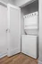 Sleek apartment with an in-unit laundry featuring stacked washer and dryer, perfect for modern convenience.