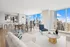 Luxurious open-concept living and dining area with panoramic city views, modern kitchen, and elegant furnishings.