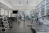 Modern gym with sleek treadmills, versatile weight racks, and panoramic city views through expansive windows.