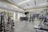 Modern gym with state-of-the-art equipment, free weights, and cardio machines, designed for an invigorating workout experience.