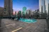 Luxurious rooftop pool with stunning city skyline views at sunset, offering ultimate relaxation and elegance.