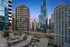 Luxurious cityscape view from a modern rooftop terrace with lounge chairs and a vibrant skyline at dusk.