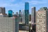 Vibrant cityscape featuring modern high-rise buildings under a clear blue sky, showcasing an urban lifestyle.