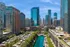 Breathtaking skyline view showcasing modern skyscrapers and serene canal in an urban oasis.
