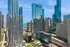 Stunning cityscape view with sleek modern skyscrapers and glistening reflections, offering luxury living and breathtaking lake vistas.