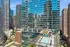 Stunning urban high-rise with a gleaming glass facade and luxurious rooftop pool, surrounded by the city skyline.