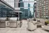 Modern rooftop terrace featuring chic outdoor seating, sleek grills, and a stunning urban skyline view.