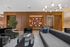 Elegant modern living room with luxurious seating, stylish bookshelves, and contemporary lighting, highlighting a sophisticated atmosphere.