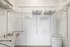 Spacious walk-in closet with organized shelving, ample storage space, and sleek modern design.