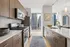 Modern apartment kitchen with sleek cabinetry, stainless steel appliances, and a stunning city view.