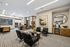 Chic and inviting office space with modern furniture, artwork, and ample natural light.
