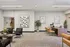 Elegant lobby area featuring modern black chairs, stylish decor, and a welcoming reception desk with warm lighting.