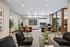 Modern office space with stylish decor, featuring comfortable seating, elegant desks, and vibrant plant accents for a productive work environment.