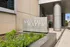 Modern building entrance at 340 East North Water Street featuring sleek architectural design and lush landscaping.