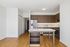 Modern kitchen with sleek wooden cabinets, stainless steel appliances, and a spacious island in stylish apartment.
