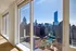 Luxurious apartment with floor-to-ceiling windows offering breathtaking cityscape and river views, featuring modern elegance and abundant natural light.