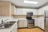 Modern kitchen with stainless steel appliances, sleek countertops, and ample cabinet space, perfect for culinary enthusiasts.