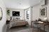 Modern bedroom with elegant decor, featuring a cozy bed, stylish desk, and natural light from a large window.