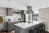 Modern kitchen with sleek gray cabinetry, white countertops, and stainless steel appliances, perfect for stylish urban living.