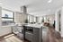 Modern open-concept kitchen and living space with elegant finishes, ample natural light, and city views.