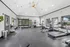 Spacious and bright gym featuring modern cardio machines, weight equipment, and vibrant decor for a dynamic workout experience.