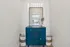 Chic and modern hallway decor featuring a stylish blue dresser with elegant gold accents, complemented by a decorative mirror and unique centerpiece.
