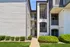 Inviting apartment exterior with modern architecture, spacious balconies, and vibrant landscaping.