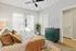 Bright and inviting bedroom with a cozy bed, stylish decor, and natural light streaming through sheer curtains.