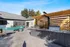 Chic outdoor patio with modern pergola, a sleek grill, and comfortable seating, perfect for entertaining in style.