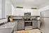 Modern kitchen with sleek stainless steel appliances, ample cabinetry, and a stylish countertop, perfect for culinary enthusiasts.