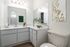 Bright and modern bathroom with elegant vanity, chic decor, and warm lighting, perfect for relaxation.