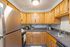 Warm and inviting kitchen with elegant wooden cabinets, sleek countertops, and modern stainless steel appliances.