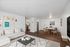 Contemporary open-plan living room with cozy seating, modern art, sleek dining area, and elegant hardwood flooring.