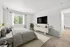 Elegant bedroom with plush bedding, large window view, modern decor, flat-screen TV, and ample natural light.