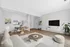 Sleek open-concept living room with modern decor, featuring a cozy sectional, elegant dining set, and chic TV area, perfect for stylish city living.