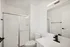 Sleek modern bathroom showcasing a pristine walk-in shower, elegant vanity with a stylish sink, and contemporary fixtures.