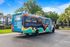 Vibrant student housing shuttle bus promoting ReNew Tallahassee with colorful graphics and QR code for innovative student living at gated community.