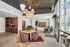 Contemporary office space with modern pendant lighting, stylish seating, and ample natural light through large windows.