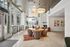 Bright and modern lounge area with stylish seating, large windows, and chic pendant lighting.