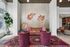 Chic lounge area with patterned sofa, colorful chairs, and artistic fish mural, perfect for relaxation and social gatherings.