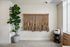 Chic interior corner featuring a lush potted plant, artsy rope wall hanging, and modern minimalist decor.