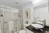 Elegant bathroom with a modern vessel sink, glass shower doors, and chic cactus artwork.