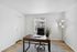 Bright and modern office space with a sleek wooden desk, ergonomic chair, and natural light streaming through a window, perfect for productivity.