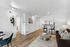 Modern open-concept living room and dining area with sleek wooden flooring, stylish decor, and a cozy seating arrangement.