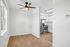 Bright and modern kitchen with stainless steel appliances, sleek wooden flooring, and a ceiling fan, ensuring a stylish and comfortable dining experience.