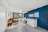 Bright and inviting laundry room with modern washing machines, cozy seating area, and large window for natural light.