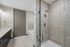 Elegant modern bathroom with sleek glass shower, spacious tub, and stylish vanity.