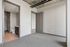 Modern apartment interior with open doorway revealing a sleek bathroom featuring stylish gray tones and contemporary finishes.