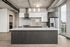 Modern kitchen with sleek cabinetry, stainless steel appliances, and a stylish island, featuring panoramic city views through large windows.
