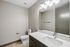 Modern bathroom featuring sleek fixtures, a spacious countertop, and contemporary lighting.